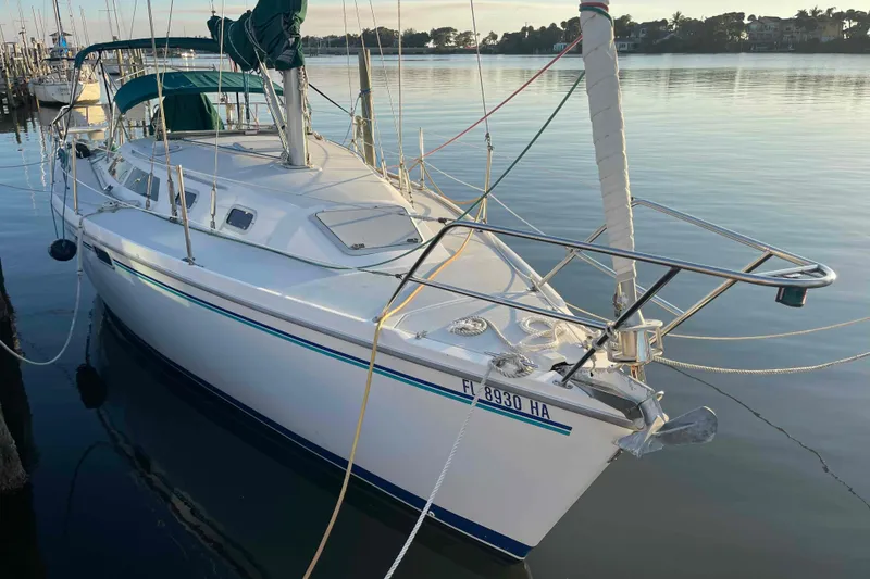 The Image of Sailboat Catalina 320 docked in calm waters at sunset. - 0
