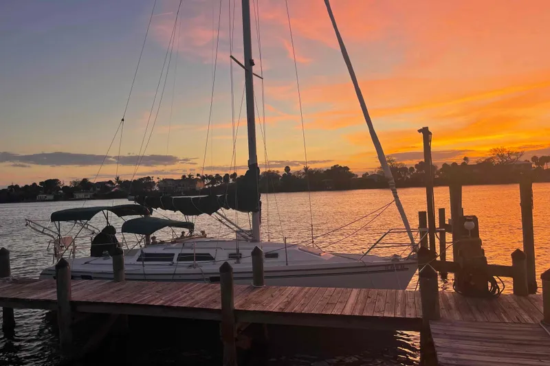 Slide: The Image of Catalina 320 sailboat docked at sunset, 1995 model, serene waterfront view. - 119