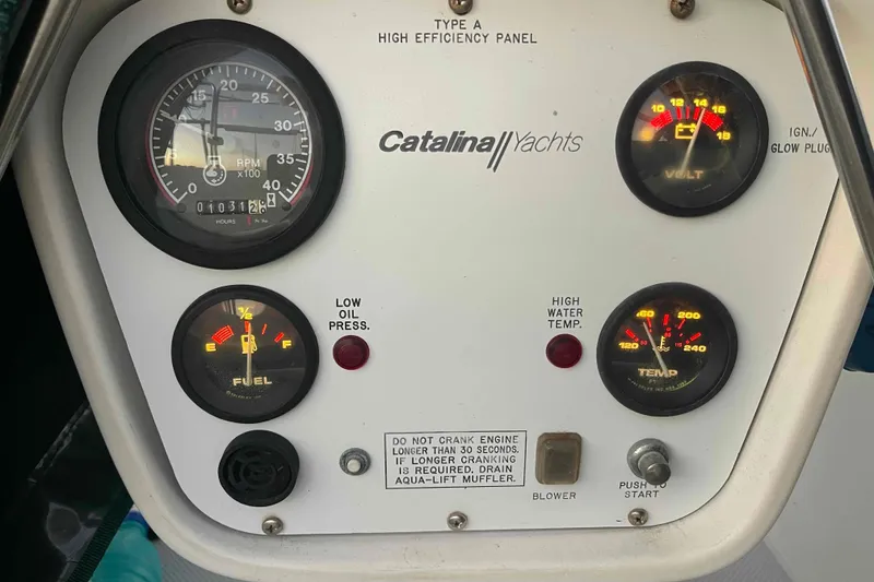 Slide: The Image of Person in protective gear working on Catalina 320 boat hull. - 33