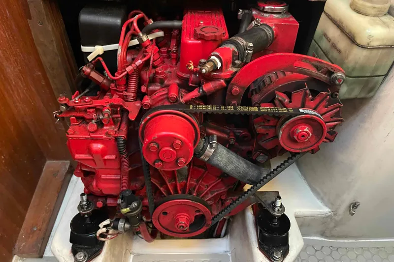 Slide: The Image of Person sanding a Catalina 320 boat hull, wearing protective gear. - 34