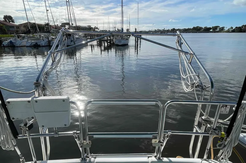Slide: The Image of Sailboat Catalina 320 docked with green covers, named "Barefoot." - 52