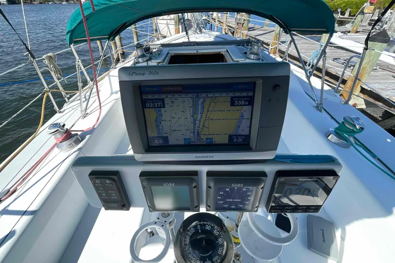 Slide: The Image of Sailboat docked at marina, view from Catalina 320 with calm water and clear sky. - 58