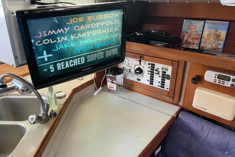 Slide: The Image of Cockpit of Catalina 320 sailboat with Garmin navigation system and teal canopy. - 72