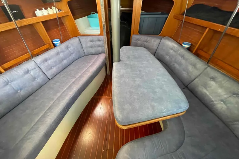 Slide: The Image of Catalina 320 sailboat deck detail with speaker reflecting sunlight on water. - 77