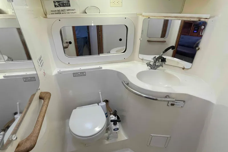 Slide: The Image of Wooden folding table on striped bedding in a 1995 Catalina 320 boat cabin. - 80