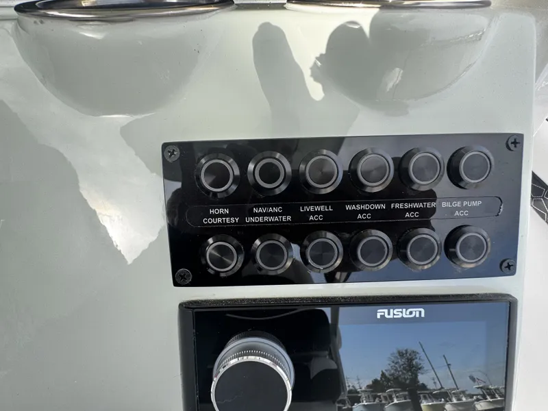 Slide: The Image of 2026 Tidewater 2500 Carolina Bay control panel with switches. - 20