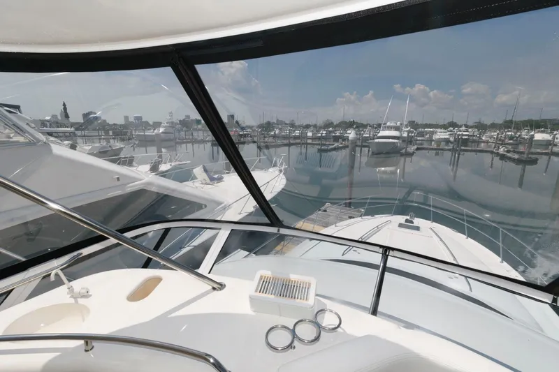 Slide: The Image of 2004 Sea Ray 480 Sedan Bridge yacht view from helm, overlooking marina. - 11