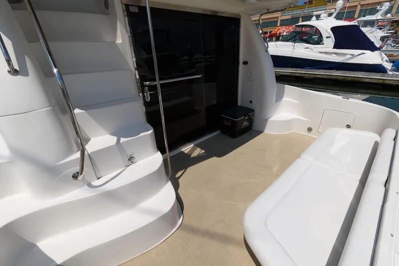 Slide: The Image of 2004 Sea Ray 480 Sedan Bridge yacht deck with seating and stairs. - 2