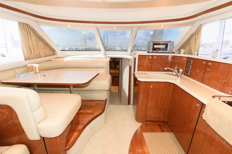 Slide: The Image of Luxurious interior of 2004 Sea Ray 480 Sedan Bridge yacht with modern kitchen and seating area. - 20