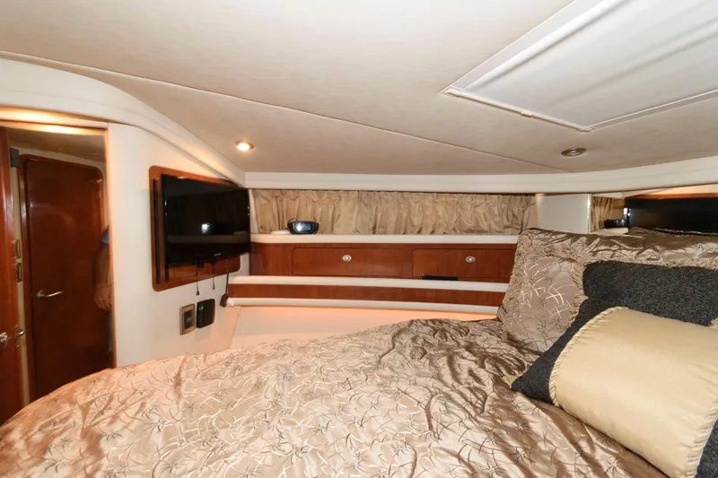 Slide: The Image of Luxurious bedroom interior of 2004 Sea Ray 480 Sedan Bridge yacht with elegant bedding. - 24