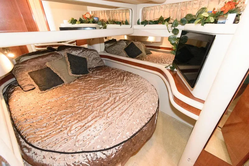 Slide: The Image of Luxurious bedroom interior of 2004 Sea Ray 480 Sedan Bridge yacht with elegant bedding. - 26