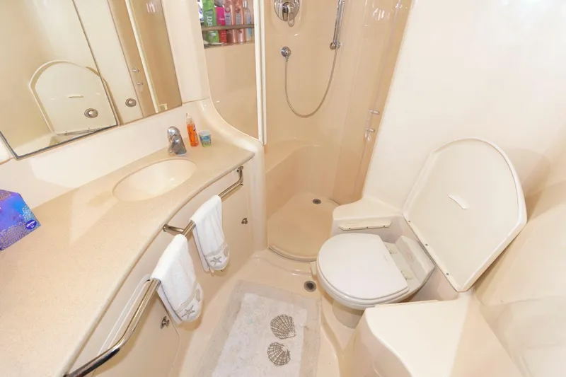 Slide: The Image of Luxurious bathroom in 2004 Sea Ray 480 Sedan Bridge yacht, featuring shower and toilet. - 28