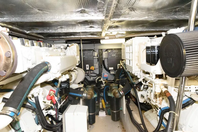 Slide: The Image of Engine room of 2004 Sea Ray 480 Sedan Bridge with visible machinery and components. - 29