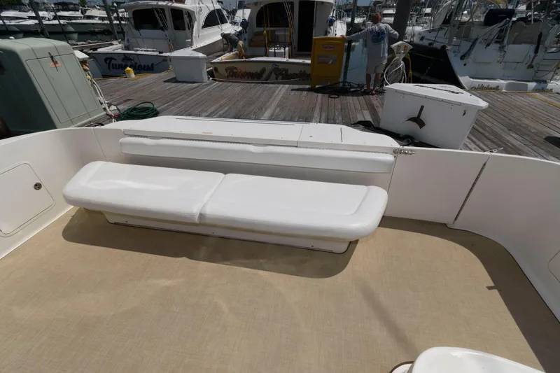 Slide: The Image of 2004 Sea Ray 480 Sedan Bridge yacht with spacious deck seating at marina. - 4