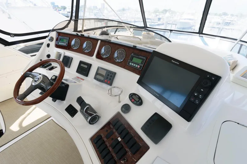 Slide: The Image of Helm of 2004 Sea Ray 480 Sedan Bridge with navigation instruments and steering wheel. - 7