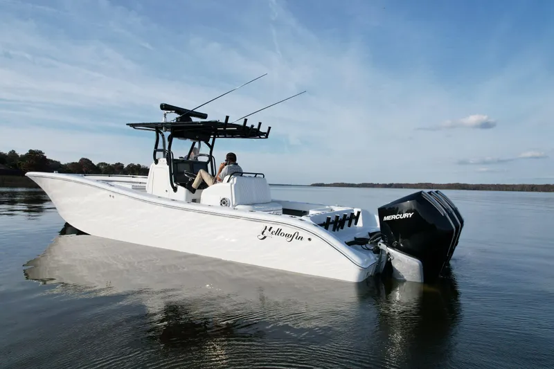 Slide: The Image of 2009 Yellowfin 36 Offshore boat on calm water, featuring Mercury engines. - 10