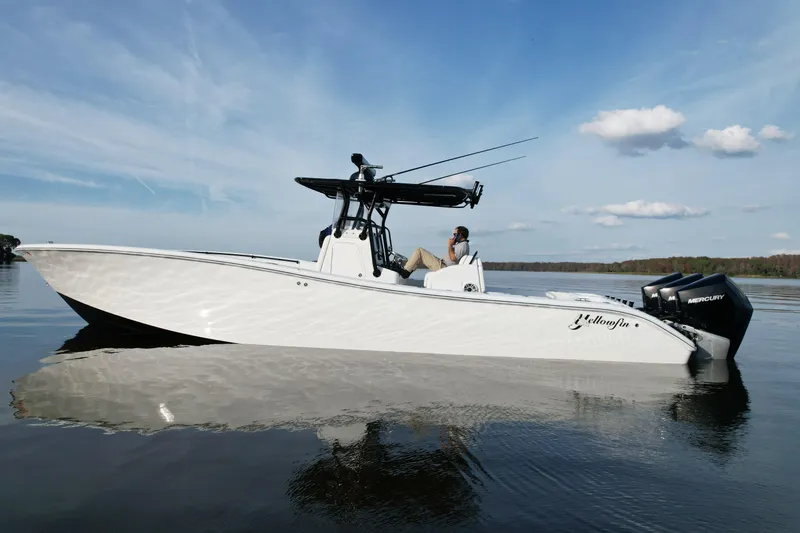 Slide: The Image of 2009 Yellowfin 36 Offshore boat on calm water, featuring dual Mercury engines. - 11