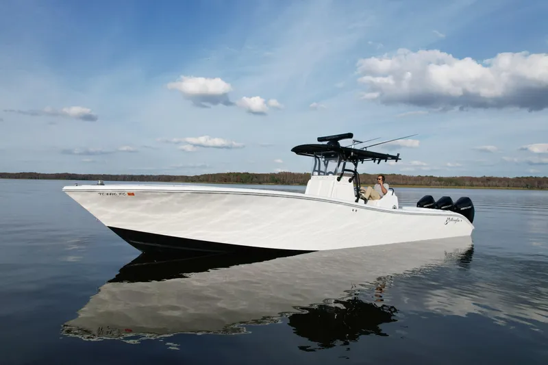 Slide: The Image of 2009 Yellowfin 36 Offshore boat on calm water under a partly cloudy sky. - 12