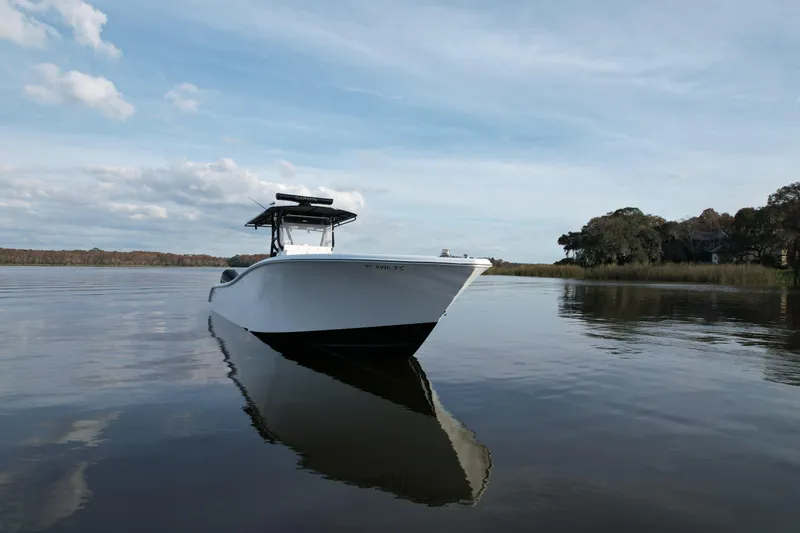 Slide: The Image of 2009 Yellowfin 36 Offshore boat on calm water under a partly cloudy sky. - 13
