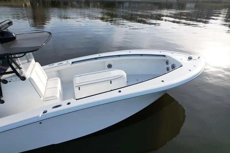 Slide: The Image of 2009 Yellowfin 36 Offshore boat on calm water, showcasing sleek design and spacious deck. - 16