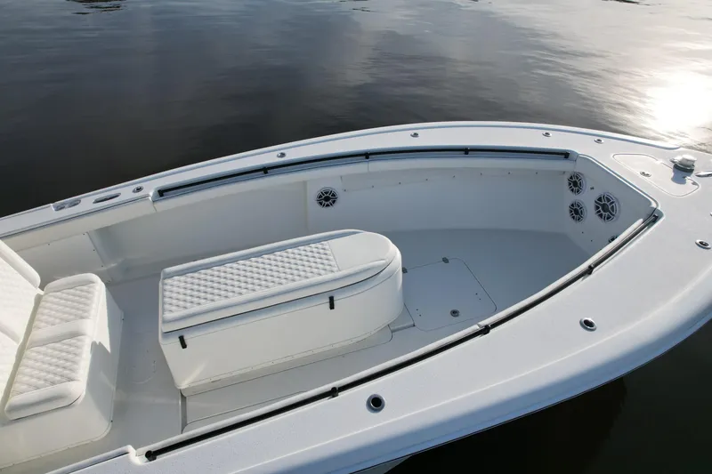 Slide: The Image of 2009 Yellowfin 36 Offshore boat interior with cushioned seating and speakers. - 17