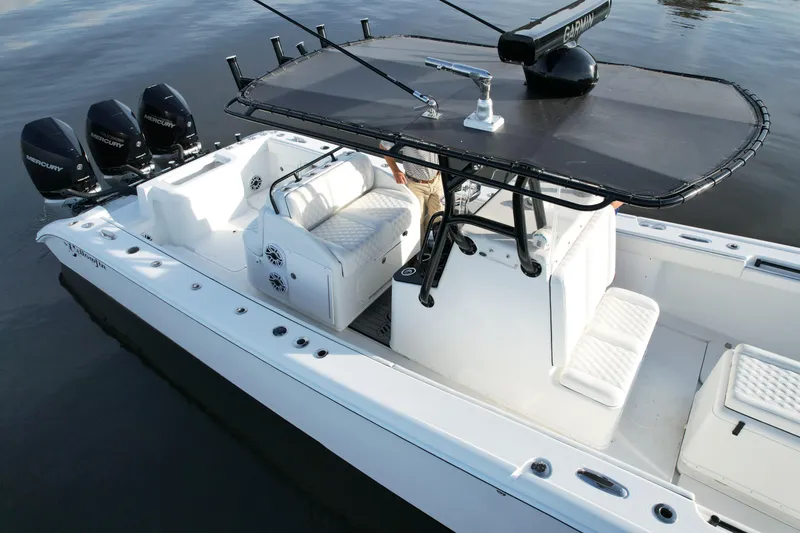 Slide: The Image of 2009 Yellowfin 36 Offshore boat with triple Mercury engines on calm water. - 19