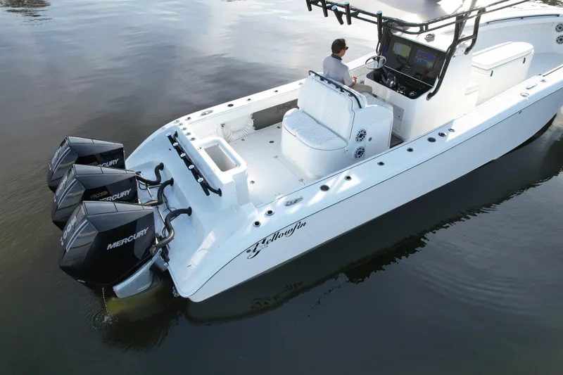 Slide: The Image of 2009 Yellowfin 36 Offshore boat with triple Mercury engines on calm water. - 21