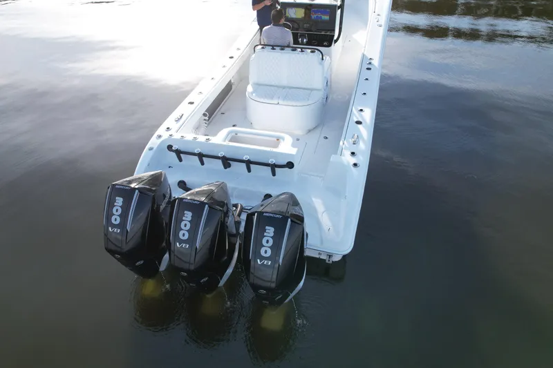 Slide: The Image of 2009 Yellowfin 36 Offshore boat with triple 300 V8 Mercury engines on calm water. - 22