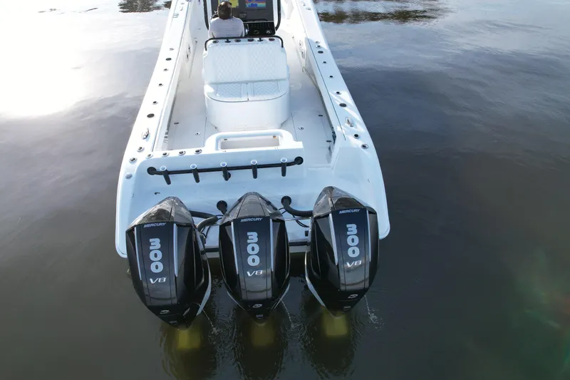 Slide: The Image of 2009 Yellowfin 36 Offshore boat with triple Mercury 300 V8 engines on calm water. - 23