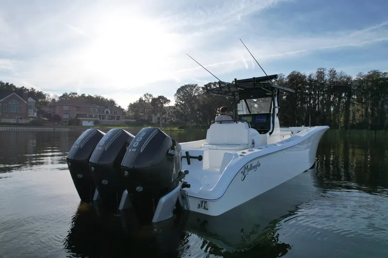 Slide: The Image of 2009 Yellowfin 36 Offshore boat with triple Mercury engines on a calm lake. - 5