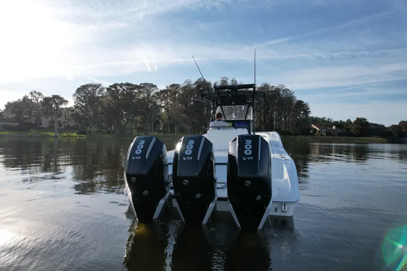 Slide: The Image of 2009 Yellowfin 36 Offshore boat with triple 300 V8 engines on a calm lake. - 6