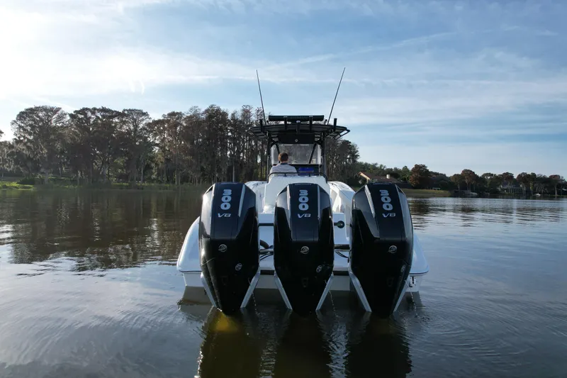 Slide: The Image of 2009 Yellowfin 36 Offshore boat with triple 300 V8 engines on a calm lake. - 7