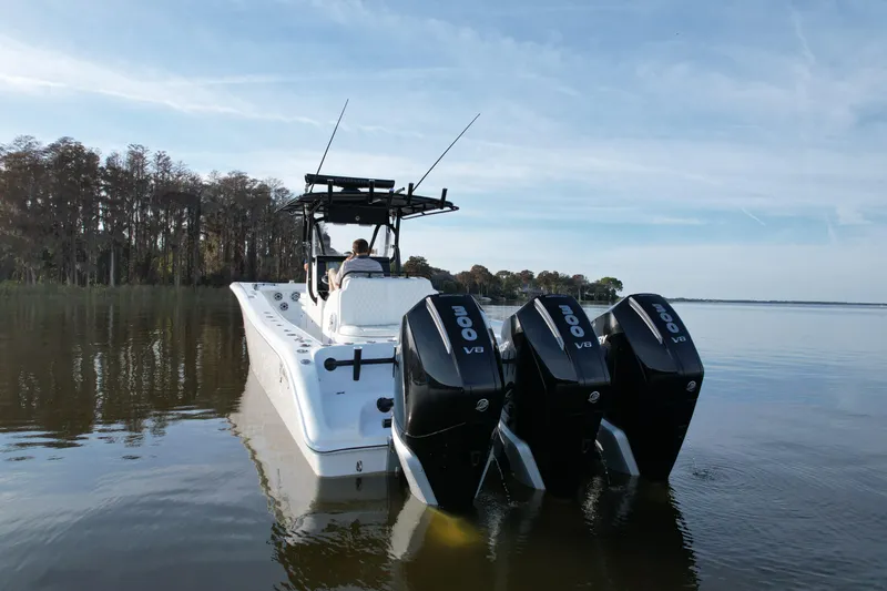 Slide: The Image of 2009 Yellowfin 36 Offshore boat with triple V8 engines on calm water. - 8