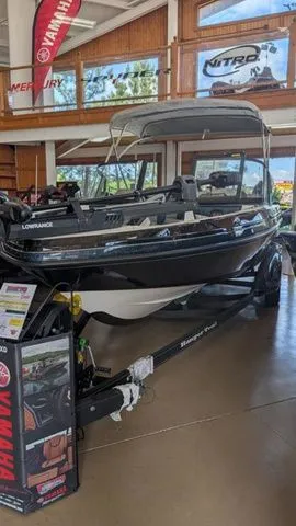 Slide: The Image of 2026 Ranger 2050MS boat in showroom with Yamaha accessories. - 2