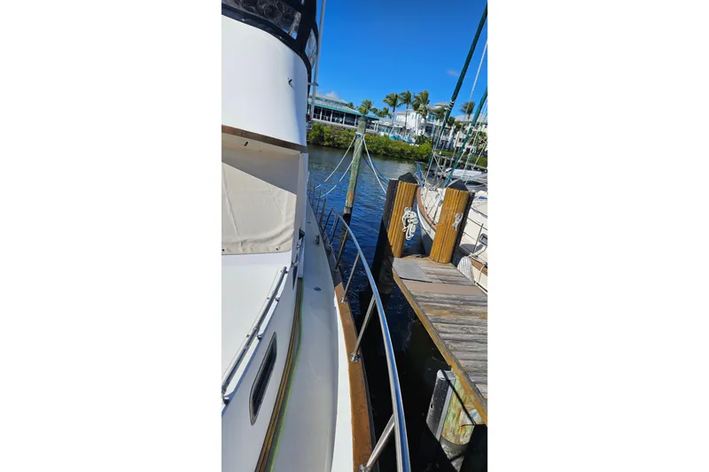 Slide: The Image of 1984 Albin Palm Beach 37 docked beside wooden pier on sunny day. - 10