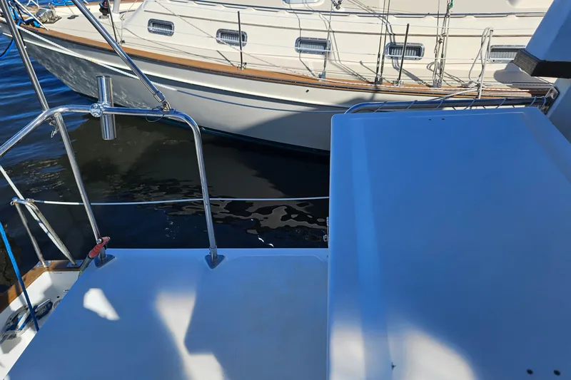 Slide: The Image of 1984 Albin Palm Beach 37 yacht docked, showcasing deck and railing details. - 15