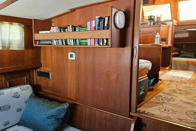 Slide: The Image of Interior of 1984 Albin Palm Beach 37 yacht with wooden shelves and cozy seating area. - 30