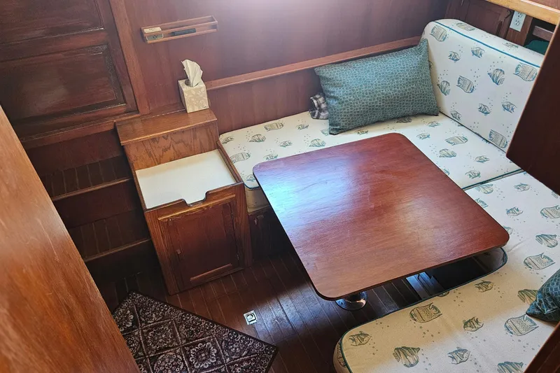 Slide: The Image of 1984 Albin Palm Beach 37 interior with wooden table and patterned seating. - 31