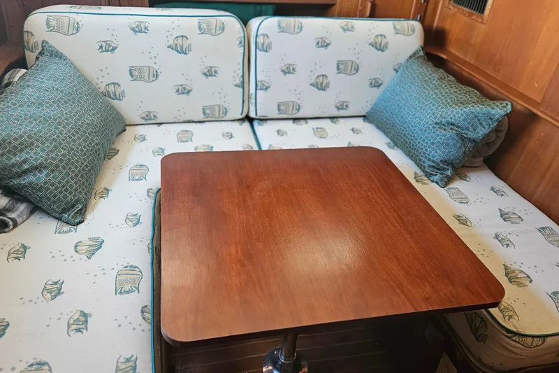 Slide: The Image of Cozy interior of 1984 Albin Palm Beach 37 with fish-patterned cushions and wooden table. - 32