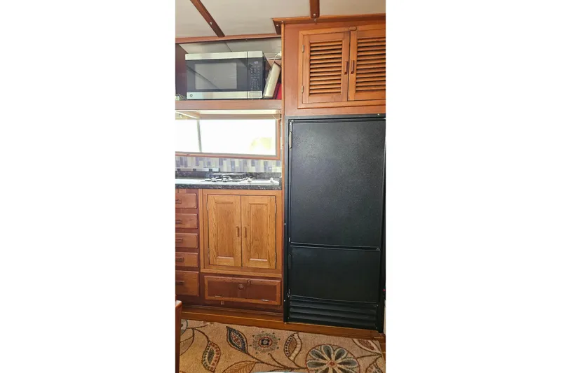 Slide: The Image of 1984 Albin Palm Beach 37 interior kitchen with wooden cabinets and appliances. - 34