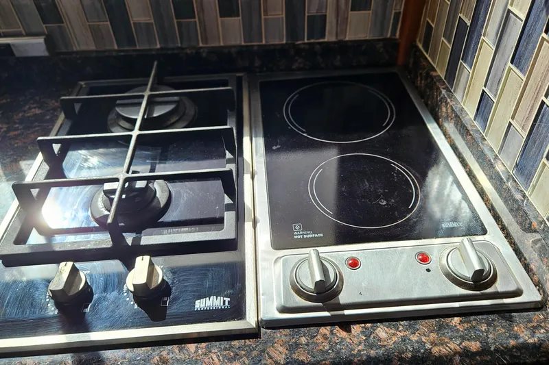 Slide: The Image of Gas and electric stovetop in 1984 Albin Palm Beach 37 yacht kitchen. - 35