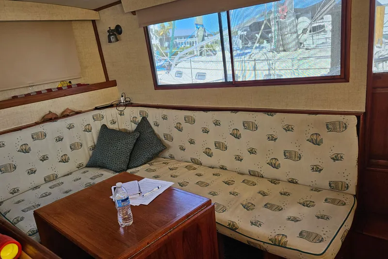 Slide: The Image of Interior of 1984 Albin Palm Beach 37 with fish-patterned seating and wooden table. - 40