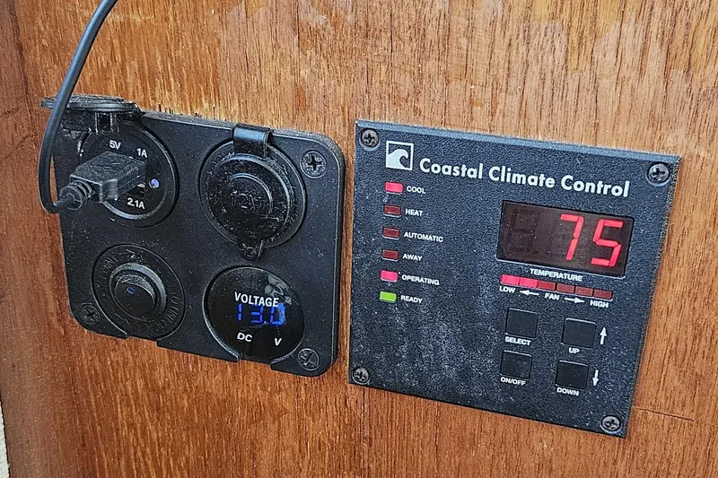 Slide: The Image of Control panel on 1984 Albin Palm Beach 37, showing voltage and climate settings. - 41