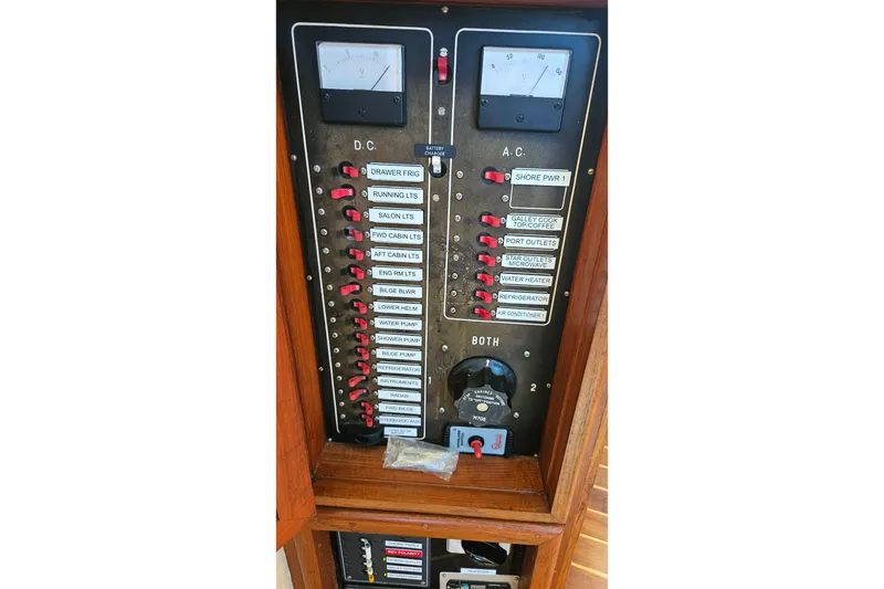 Slide: The Image of Electrical control panel on a 1984 Albin Palm Beach 37 boat, featuring DC and AC switches. - 44