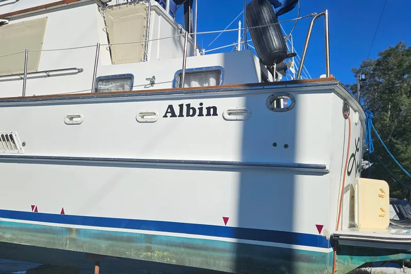 Slide: The Image of 1984 Albin Palm Beach 37 boat docked, showcasing its sleek white exterior. - 5