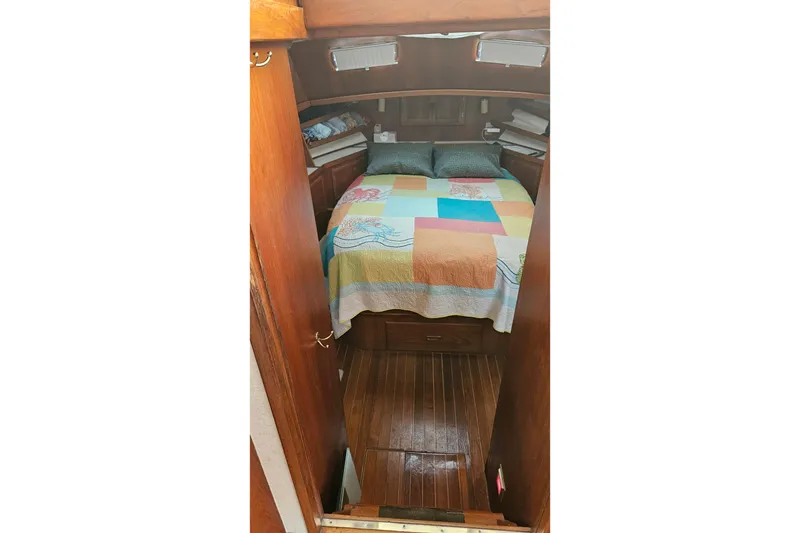 Slide: The Image of 1984 Albin Palm Beach 37 cabin interior with colorful bedspread and wooden flooring. - 52