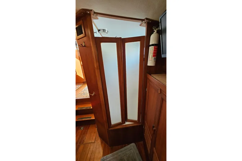 Slide: The Image of 1984 Albin Palm Beach 37 interior with wooden cabinetry and frosted glass door. - 53