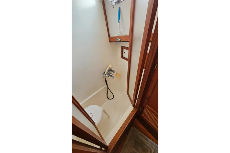 Slide: The Image of 1984 Albin Palm Beach 37 yacht bathroom with shower and wooden accents. - 54
