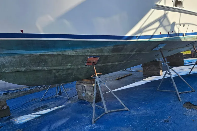 Slide: The Image of 1984 Albin Palm Beach 37 boat on stands for maintenance, hull visible. - 61