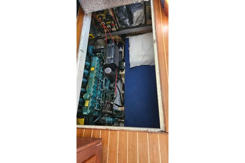 Slide: The Image of Engine compartment of 1984 Albin Palm Beach 37 with visible machinery and wiring. - 63